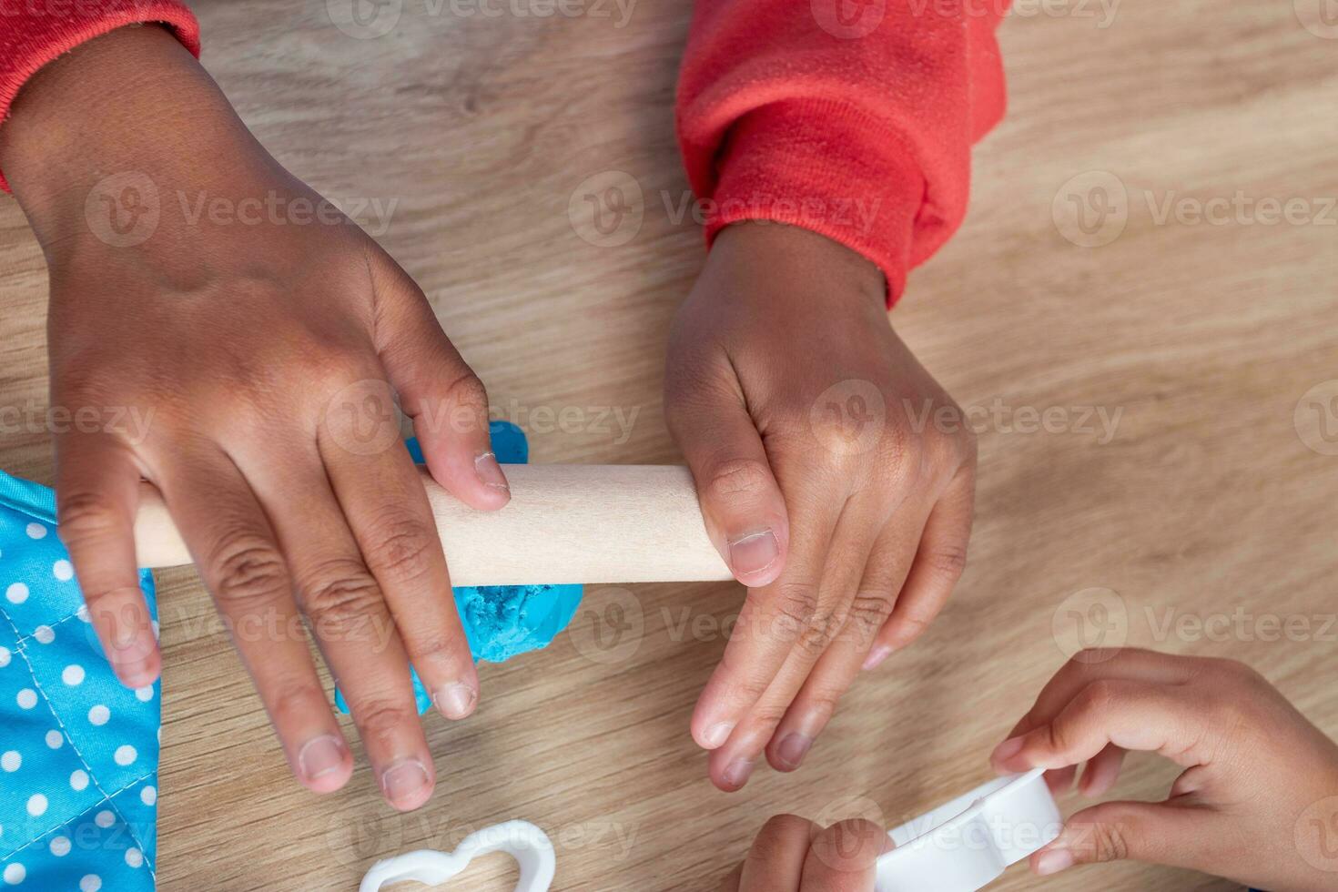 Children's hands and simulation cooking toys in the kitchen counter photo