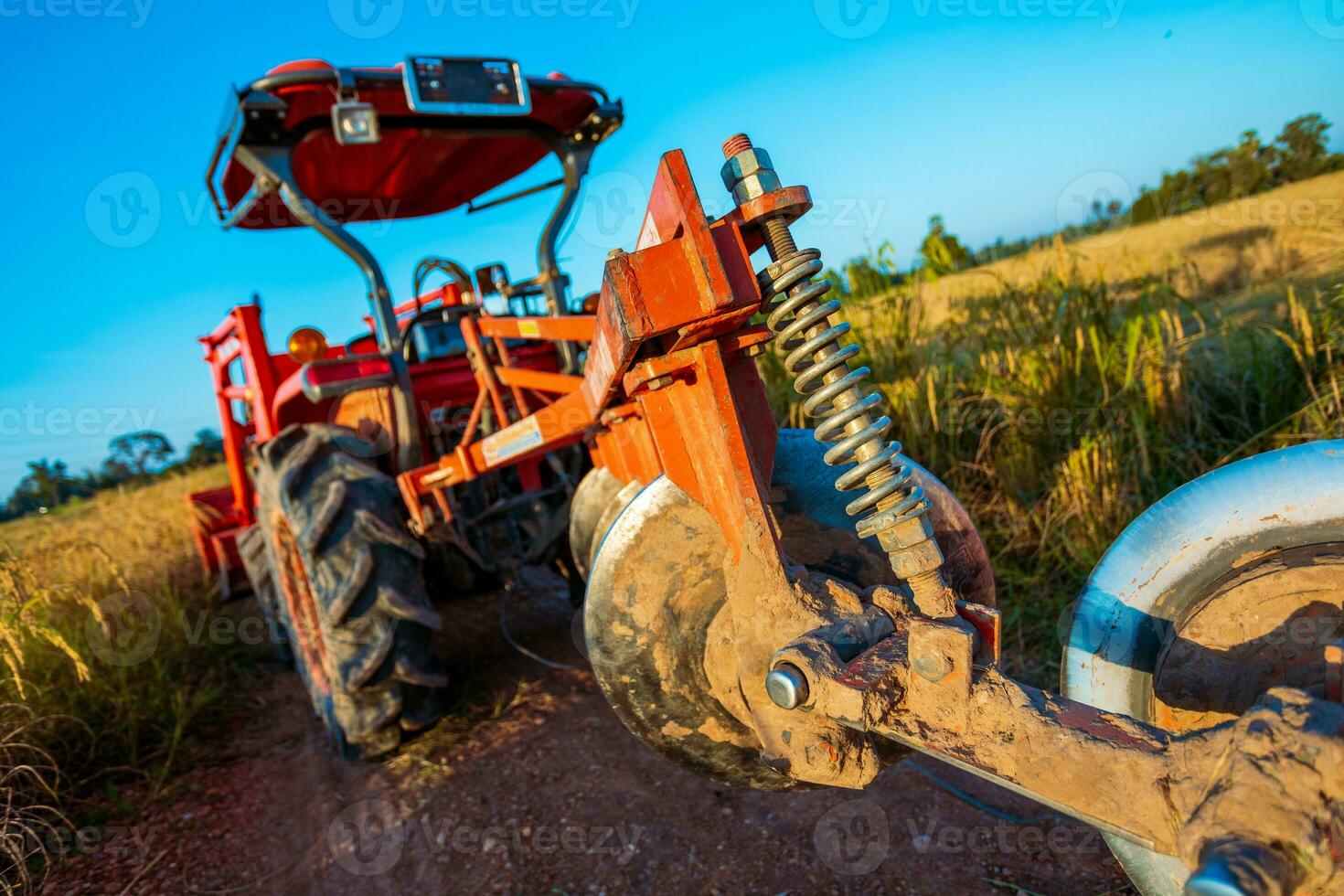 Agricultural machinery in the rice fields at sunset photo