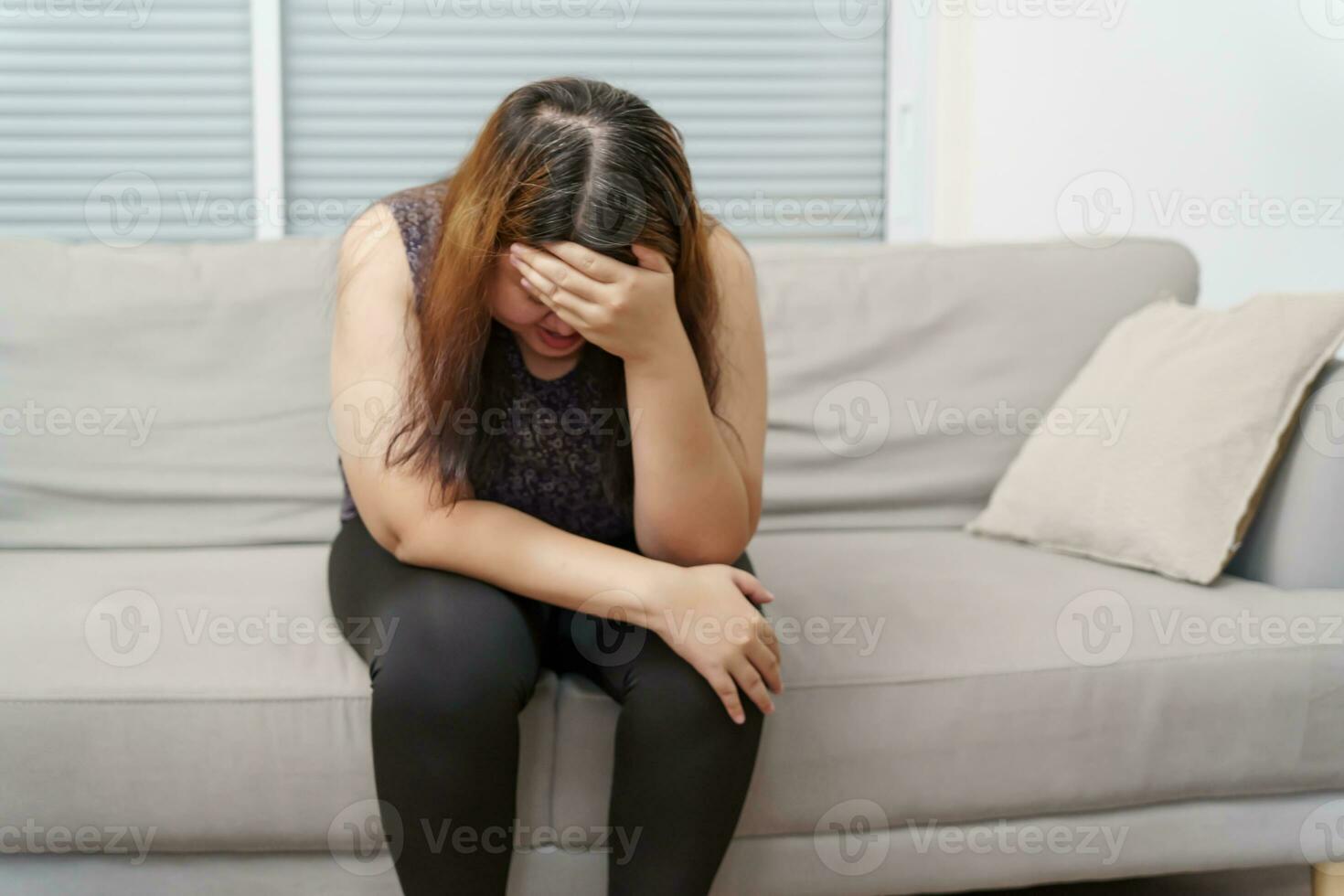 Sad Overweight plus size woman thinking about problems on sofa upset girl feeling lonely and sad from bad relationship or Depressed woman disorder mental health photo
