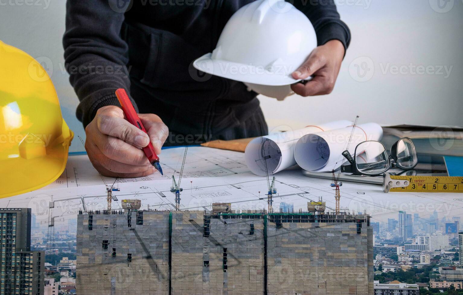 Double exposure between the work of an architect and a building under construction photo