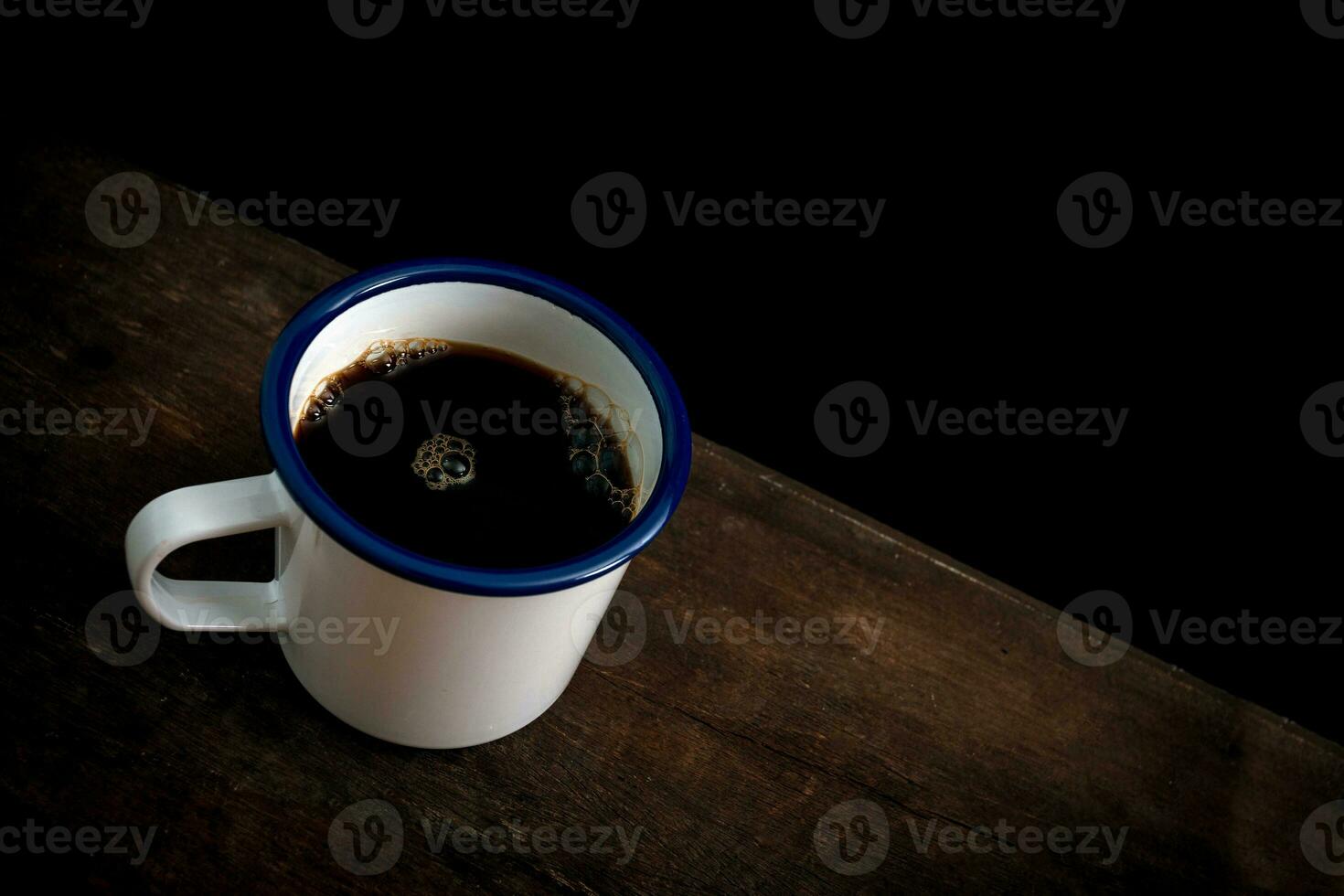 Cup of coffee on old wooden table photo