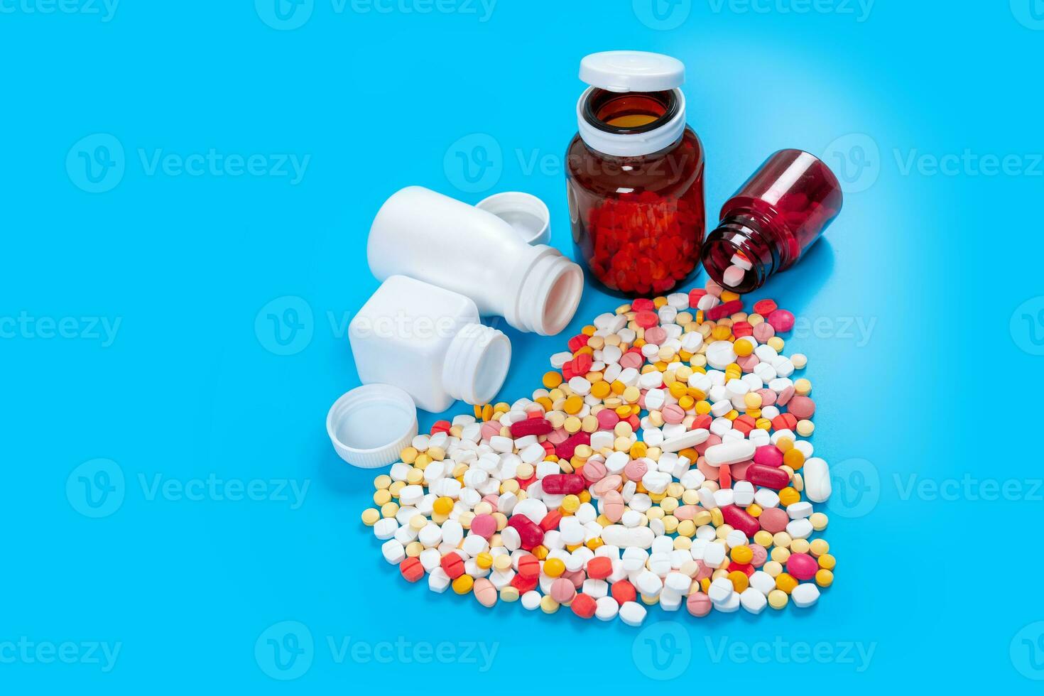 Many pills in the form of a heart Multicolored on a blue background photo