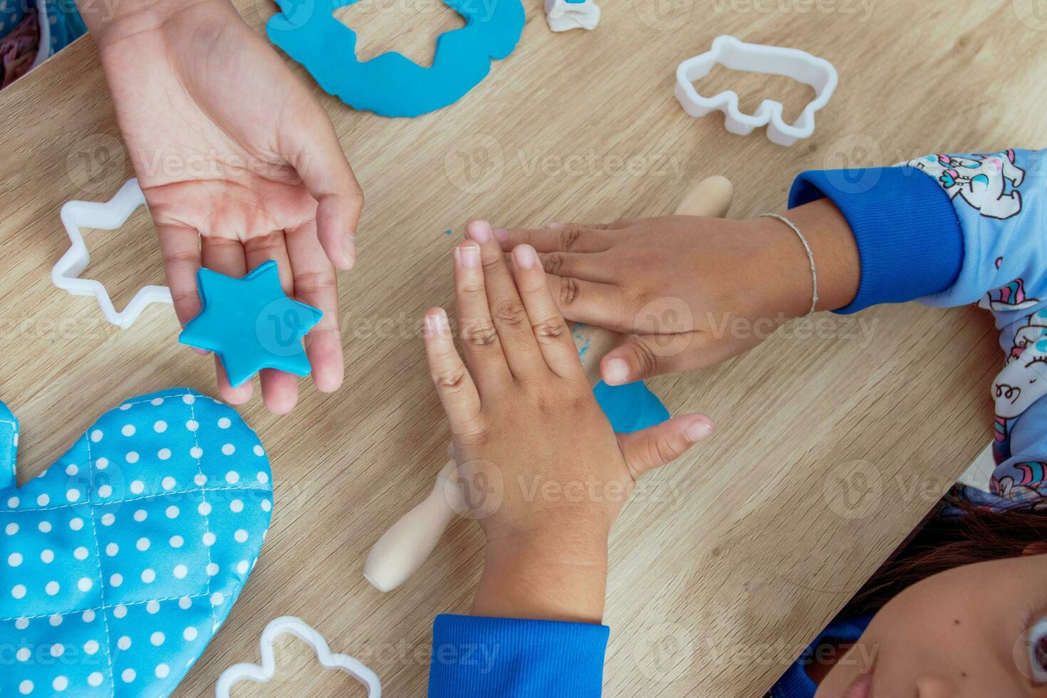 Children's hands and simulation cooking toys in the kitchen counter photo