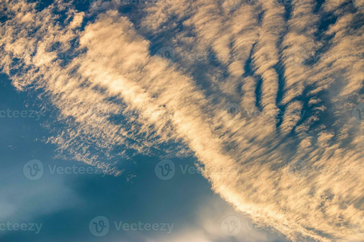 Beautiful golden clouds in the blue sky photo