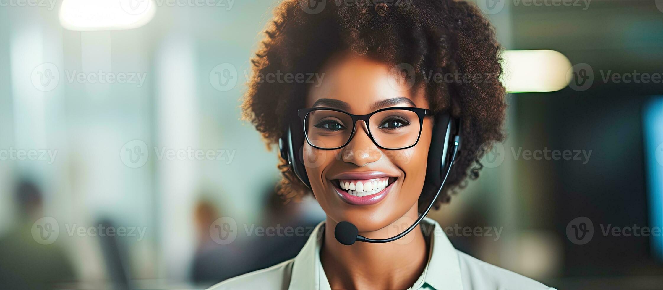 Smiling African American customer service agent with headset attending calls in office looking at camera photo