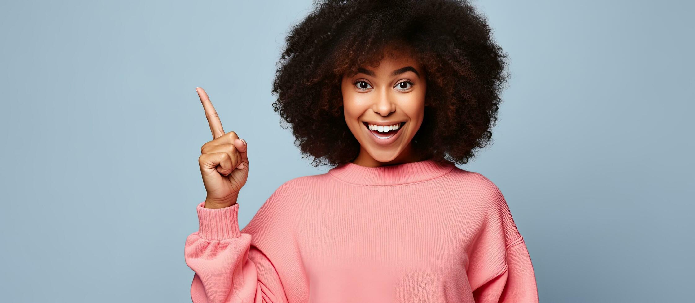 Black girl with braces pointing finger while posing against white studio background Attention Empty space for your text photo