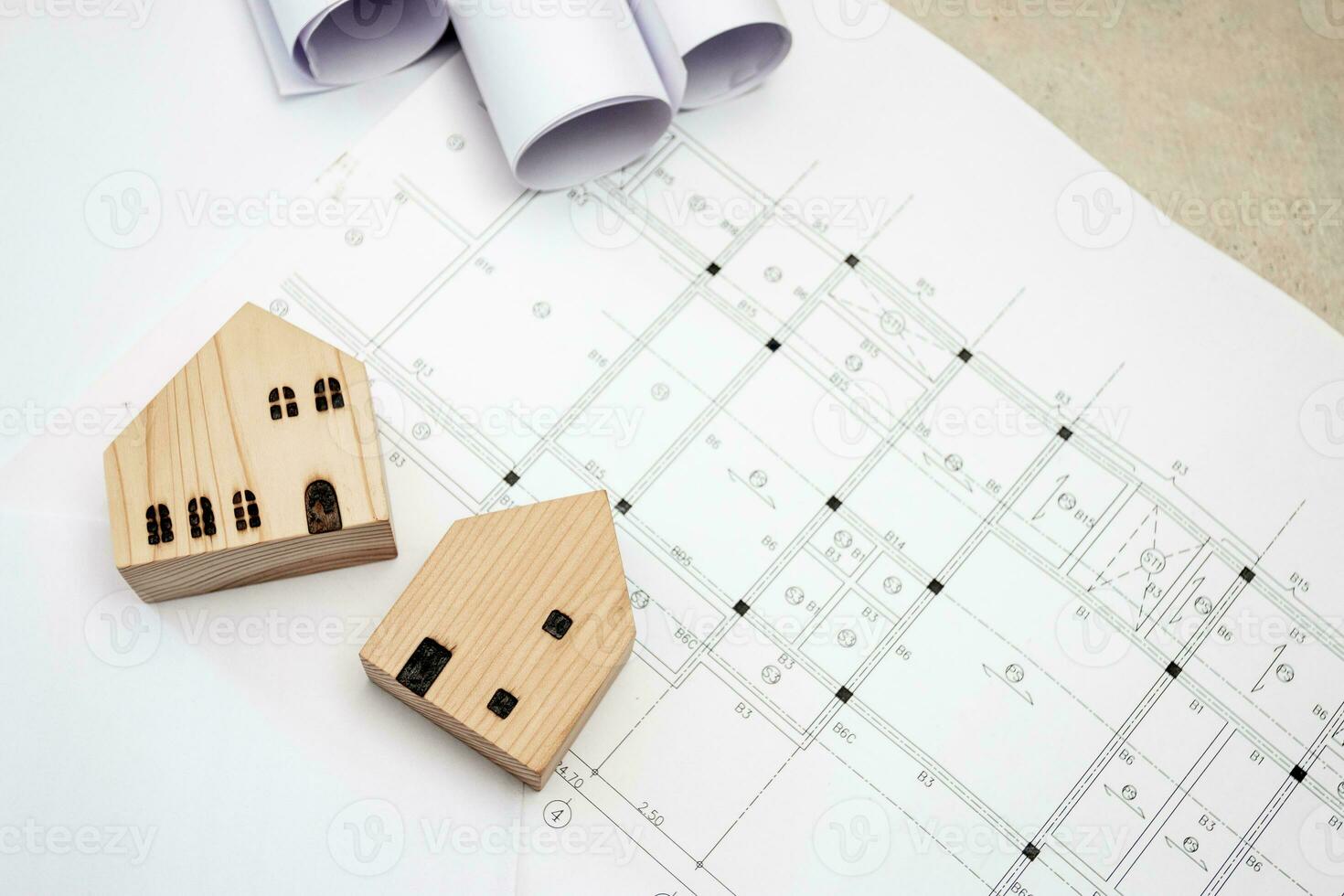 real estate and property, architecture, building, construction concept - Tiny house model on an architect's desk photo