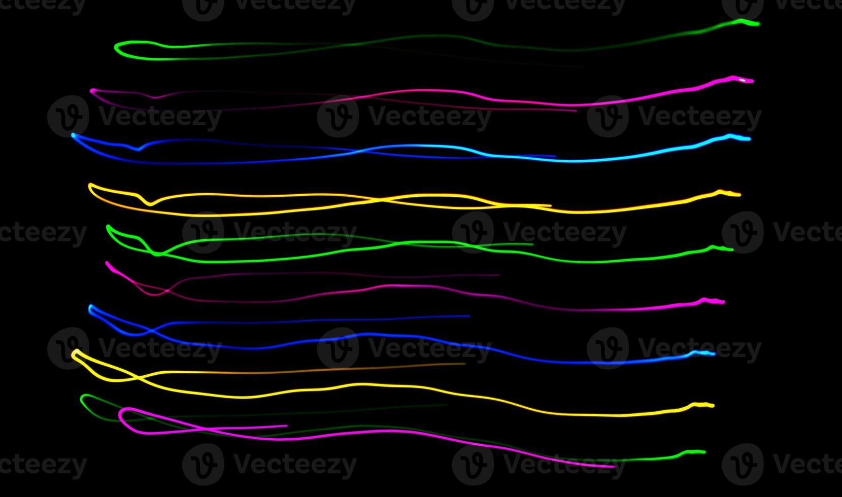 Multi color light painting photography, swirl and curve of blue, green and red light against a black background. photo