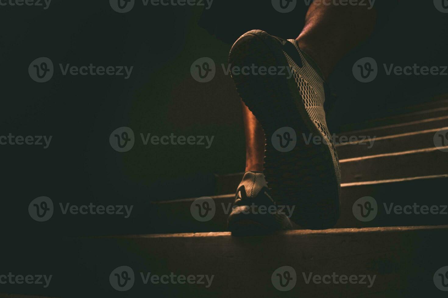 Man doing exercise by running up concrete stairs. photo