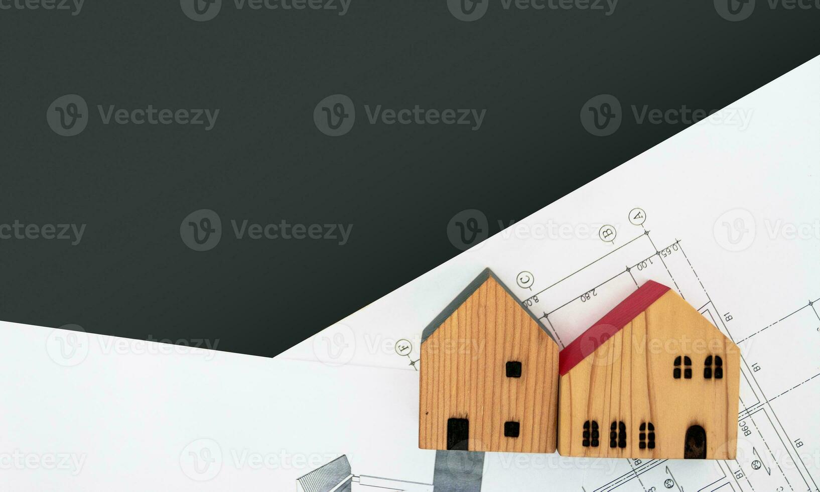 real estate and property, architecture, building, construction concept - Tiny house model on an architect's desk photo