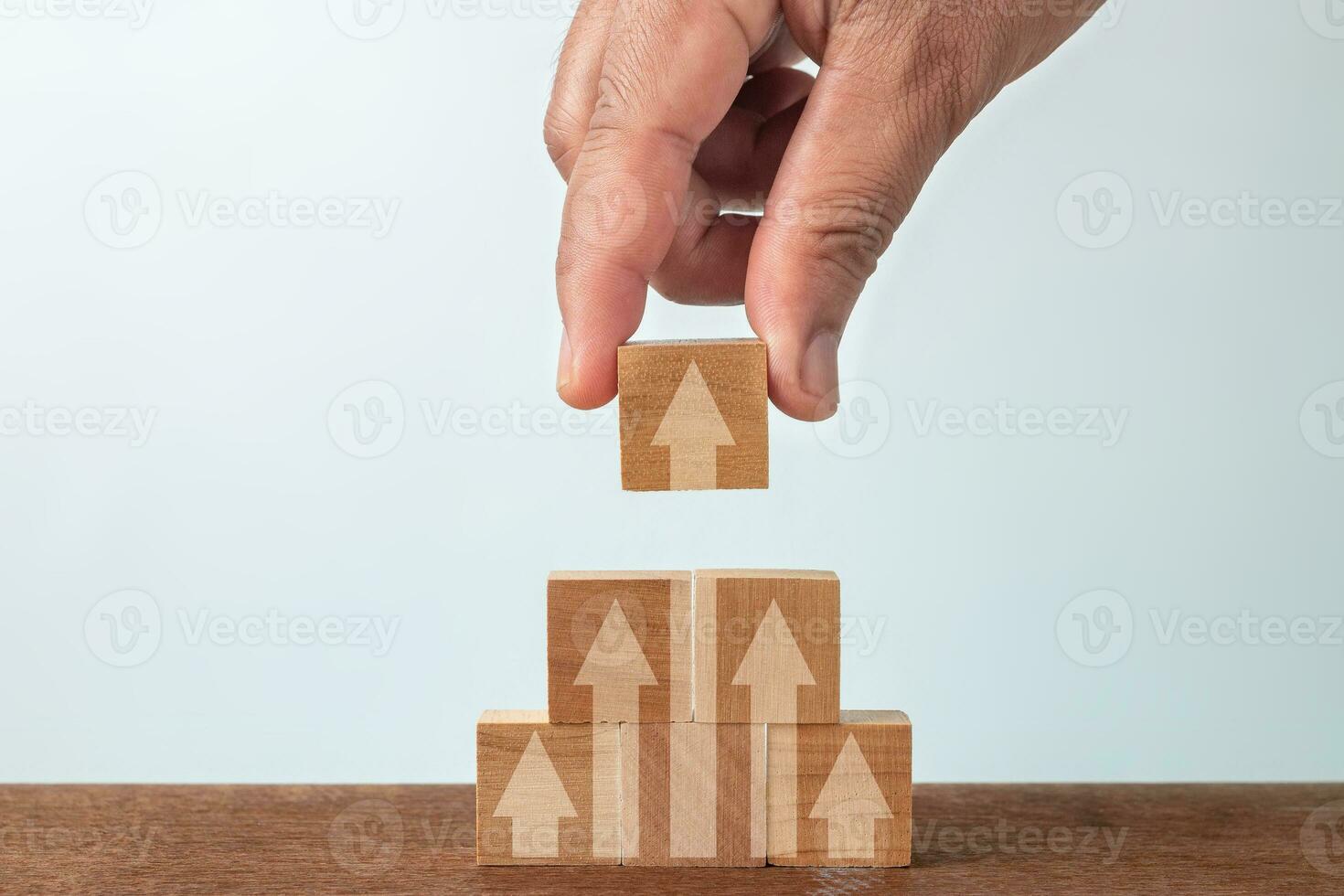 Up arrow on wooden block , Growth concept. photo