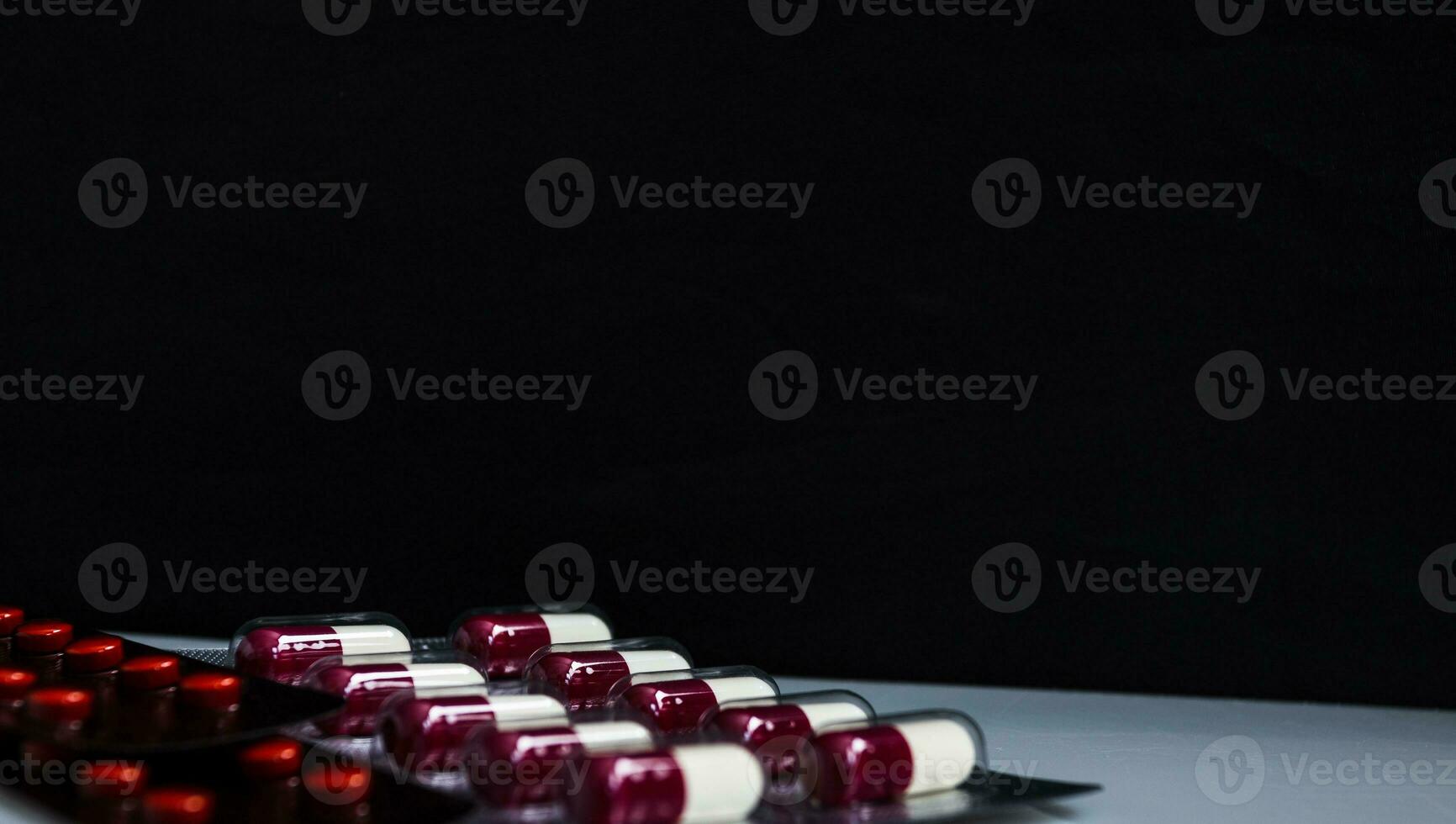 Medicine capsule panel on black background photo