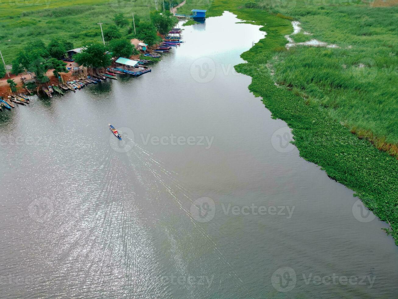 A fishing boat was sailing in a large lagoon. photo