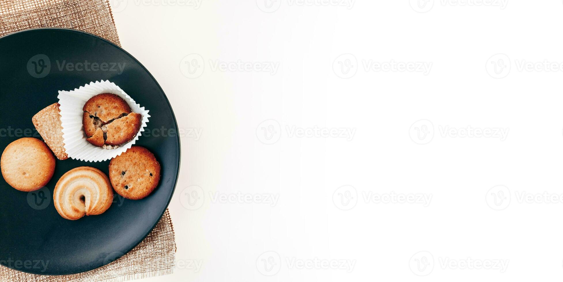 Butter cookies in a black plate on a white background. photo