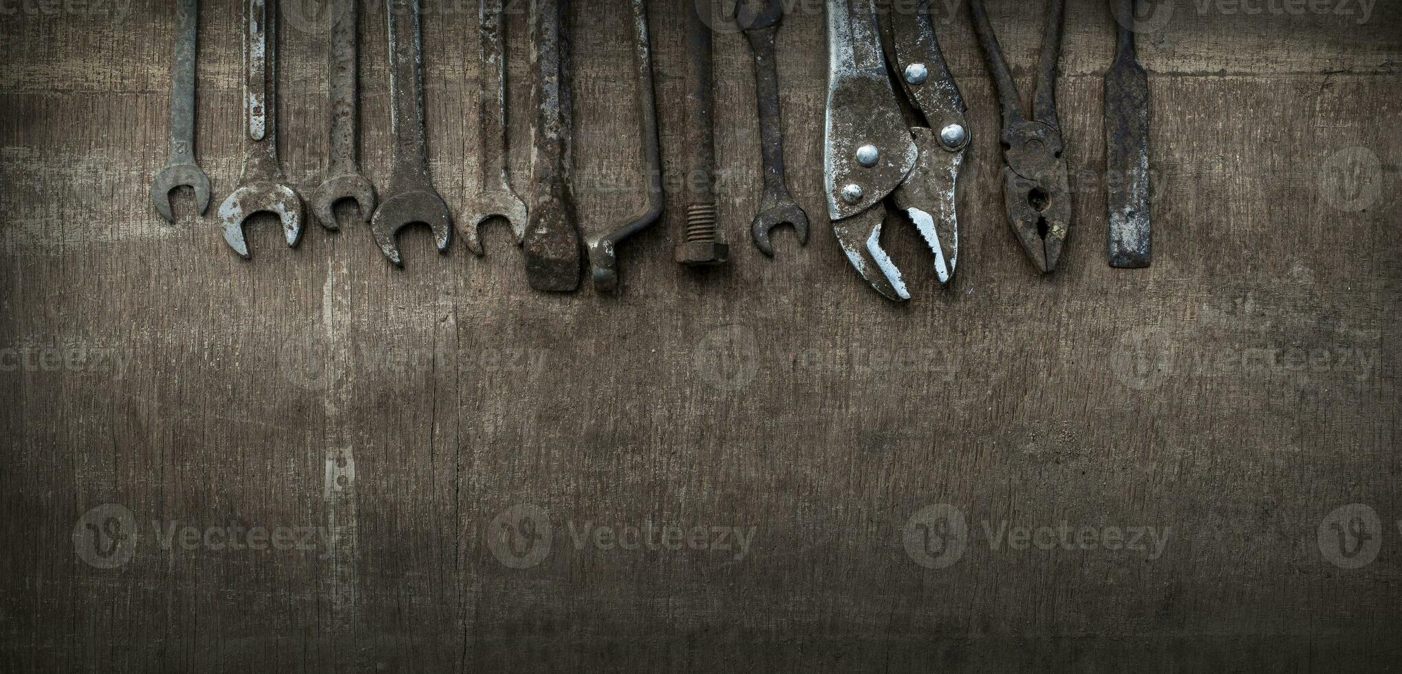 Old tools on wooden background. Old tools because they have been used long and hard. Banner background. photo