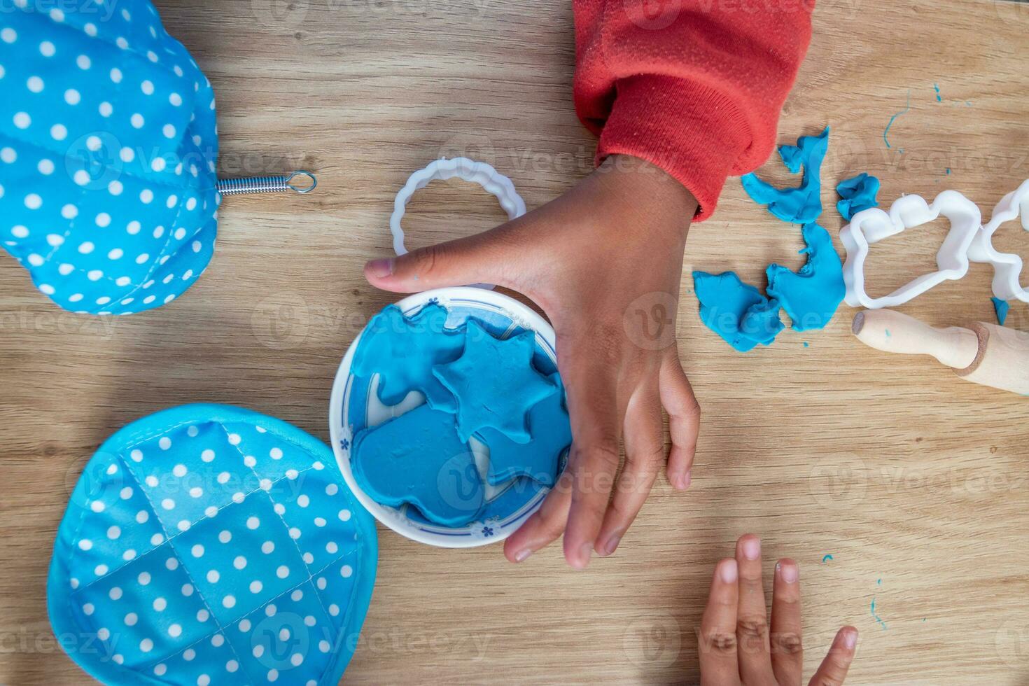 Children's hands and simulation cooking toys in the kitchen counter photo