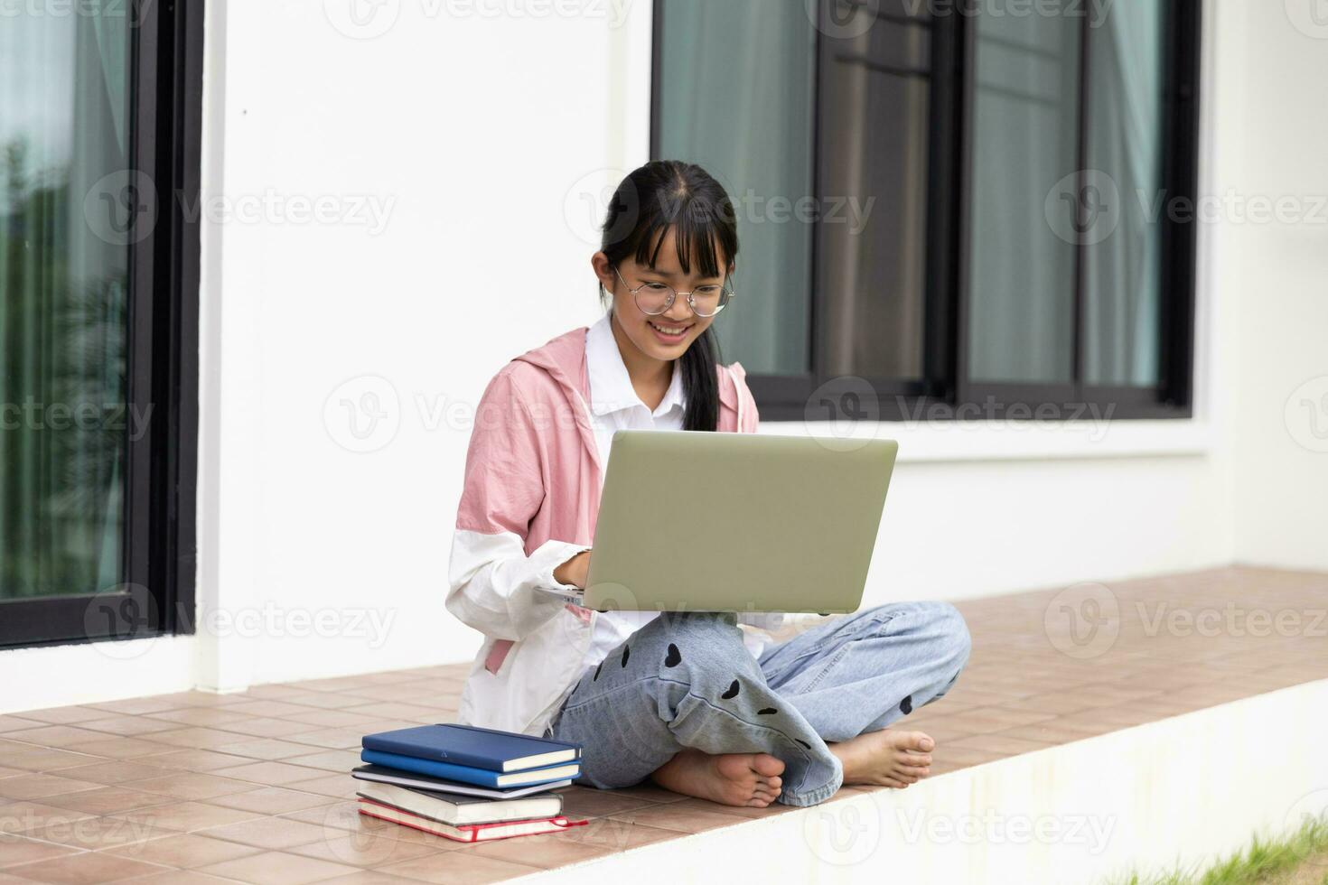 Student girl happy studying online, back to school concept. Young woman student busy study make notes in notebook and using laptop concentrated online training course technology education. photo