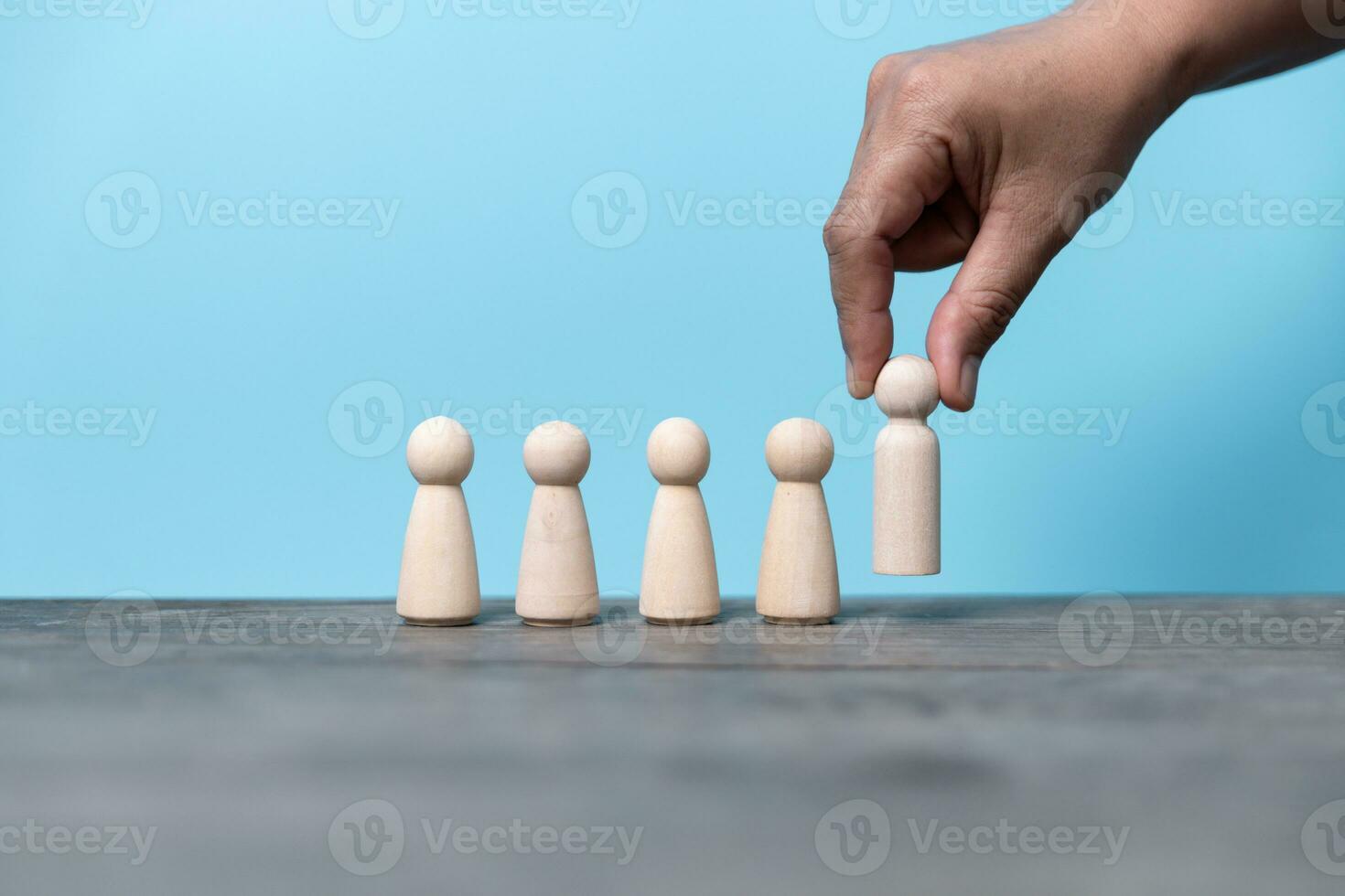 Building a strong team, Wooden blocks with people icon on blue background, Human resources and management concept. photo