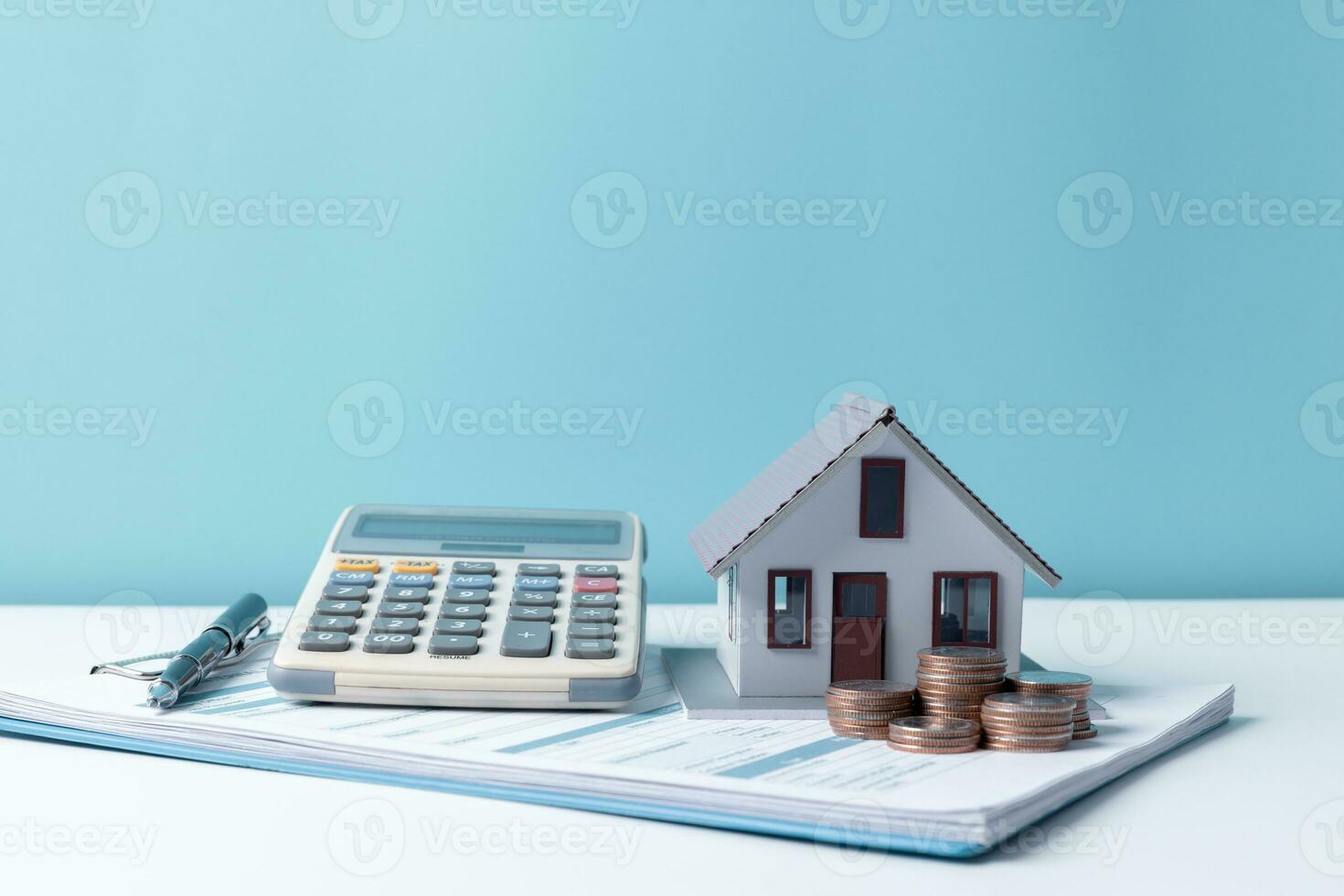 Property tax.investment planning.business real estate. View Of coin stack with house model, mortgage loading real estate property with loan money bank concept.Home sales and home insurance concept. photo