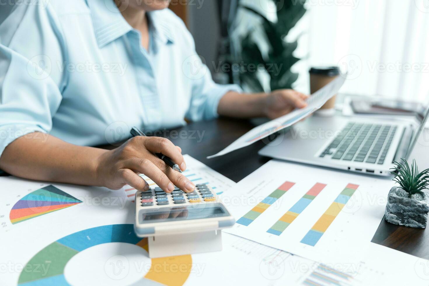 Businesswomen working to analyze, work together to discuss company financial statistics, brainstorm ideas, and graph documents on the table. photo