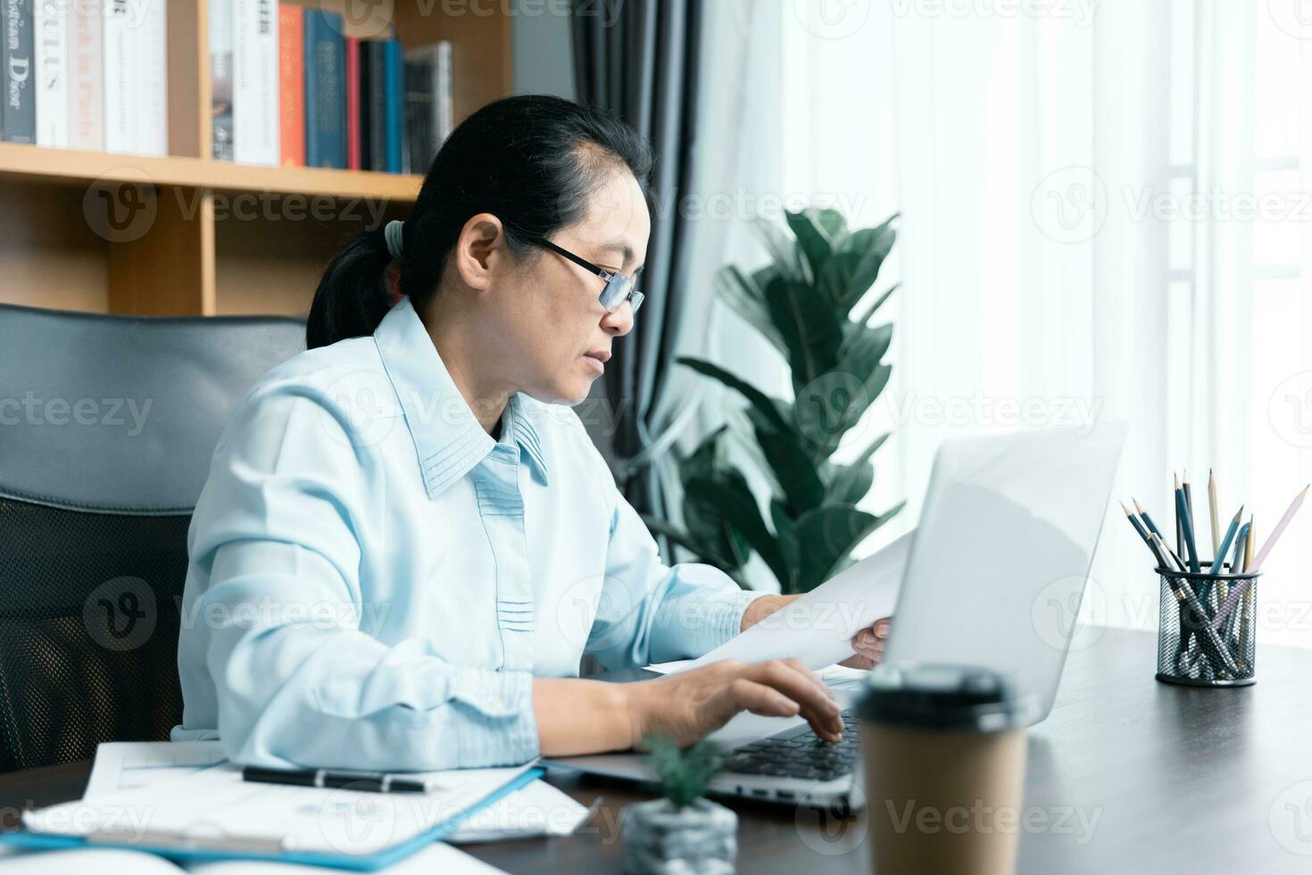 Businesswomen working to analyze, work together to discuss company financial statistics, brainstorm ideas, and graph documents on the table. photo