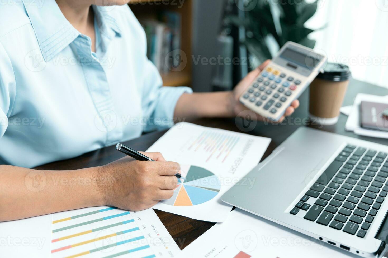 Businesswomen working to analyze, work together to discuss company financial statistics, brainstorm ideas, and graph documents on the table. photo