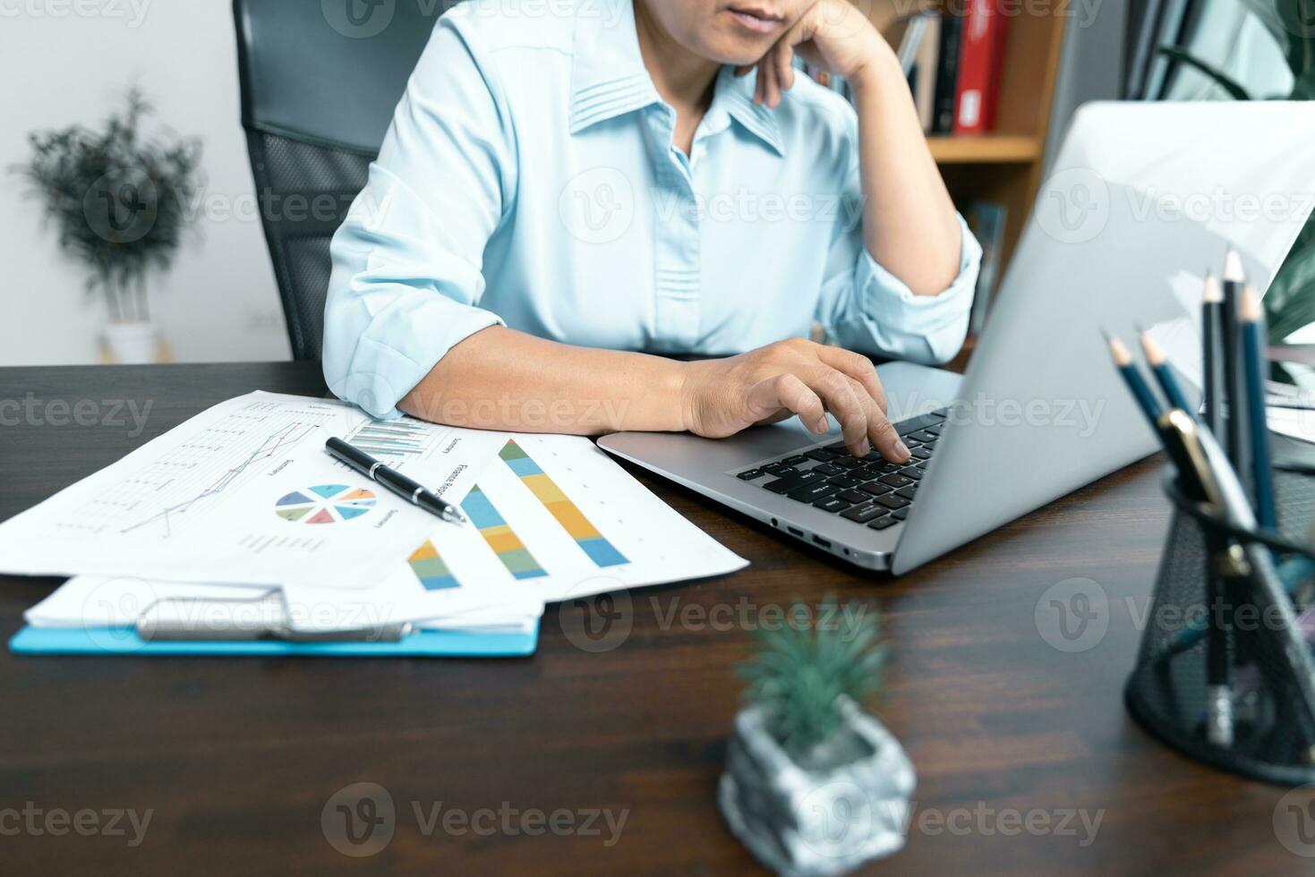 Businesswomen working to analyze, work together to discuss company financial statistics, brainstorm ideas, and graph documents on the table. photo