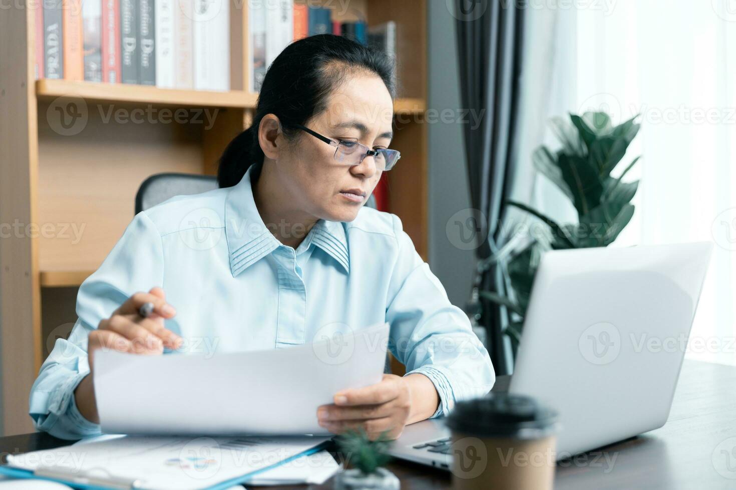 Businesswomen working to analyze, work together to discuss company financial statistics, brainstorm ideas, and graph documents on the table. photo