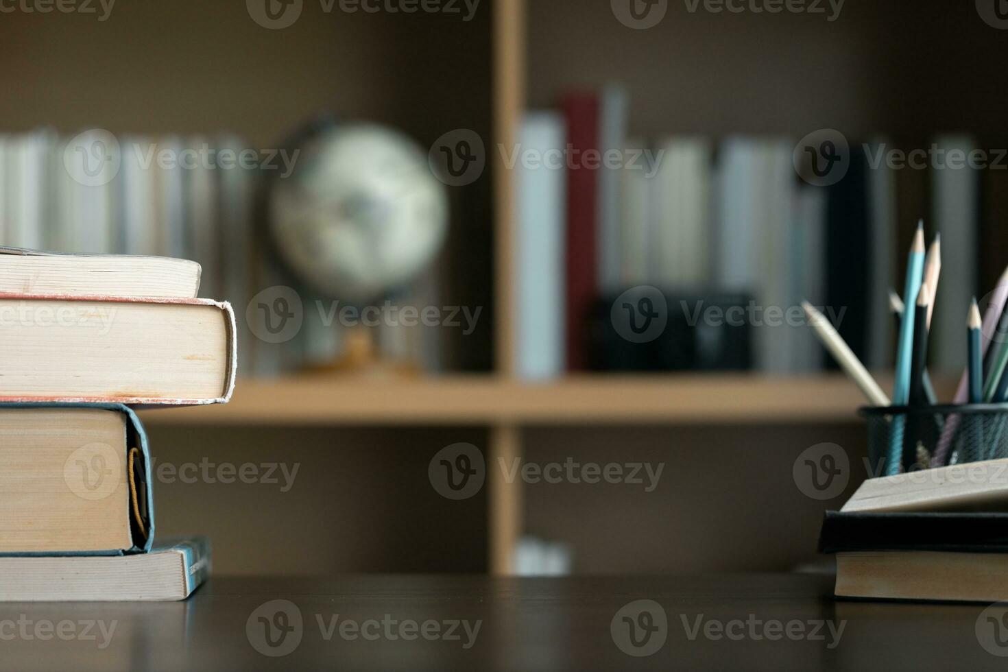 Education learning concept. Book in library with old open textbook, stack piles of literature text archive on reading desk, aisle of bookshelves in school study class room background for academic photo
