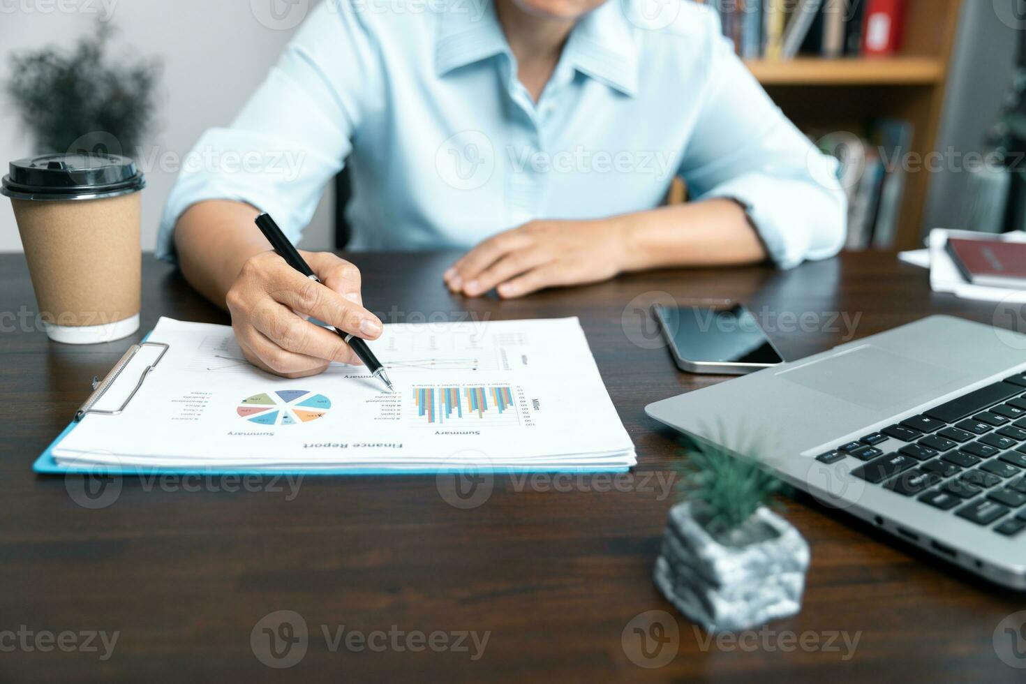 Businesswomen working to analyze, work together to discuss company financial statistics, brainstorm ideas, and graph documents on the table. photo