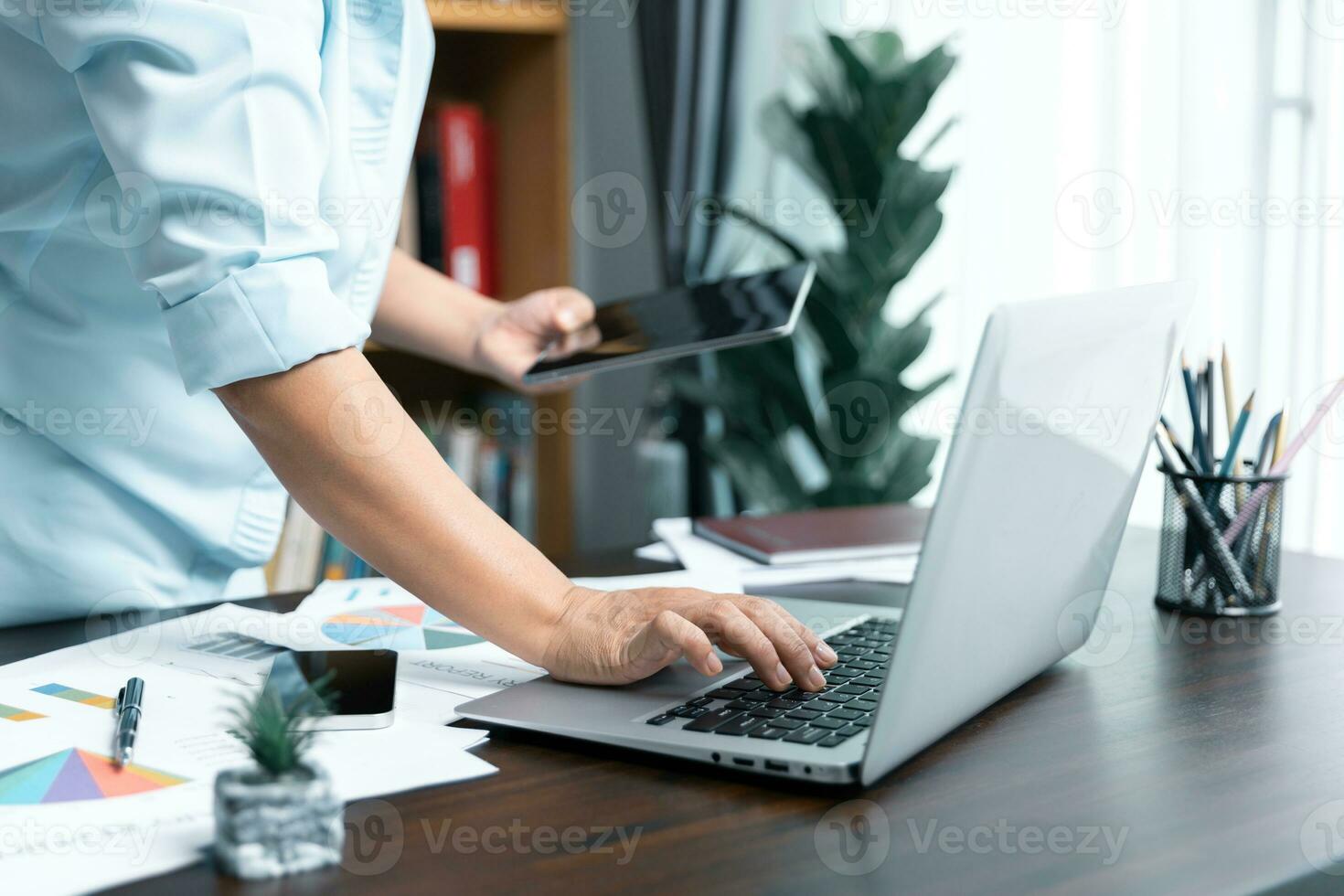 Businesswomen working to analyze, work together to discuss company financial statistics, brainstorm ideas, and graph documents on the table. photo