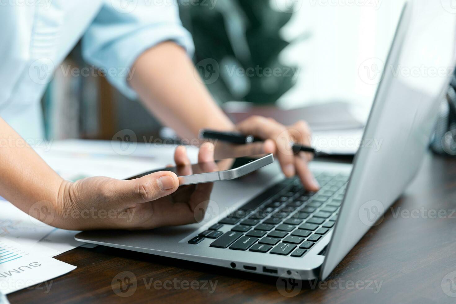 Businesswomen working to analyze, work together to discuss company financial statistics, brainstorm ideas, and graph documents on the table. photo