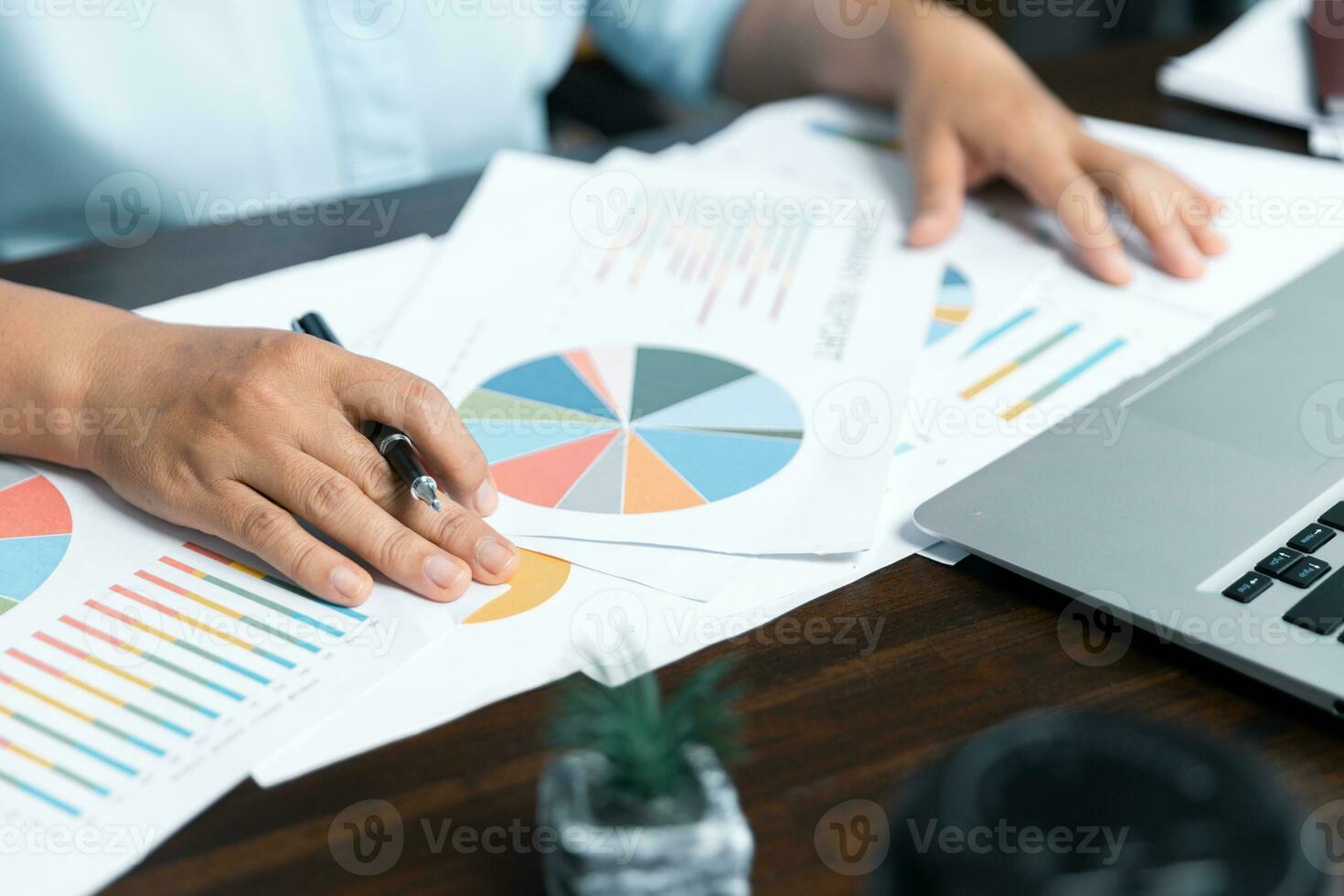 Businesswomen working to analyze, work together to discuss company financial statistics, brainstorm ideas, and graph documents on the table. photo