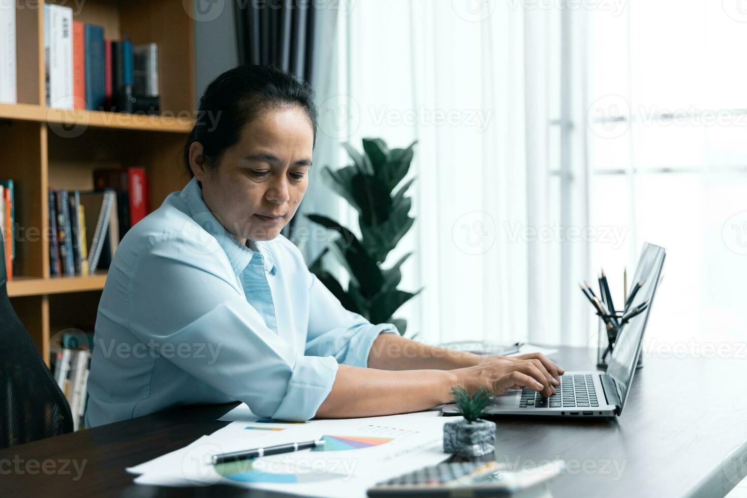 Businesswomen working to analyze, work together to discuss company financial statistics, brainstorm ideas, and graph documents on the table. photo