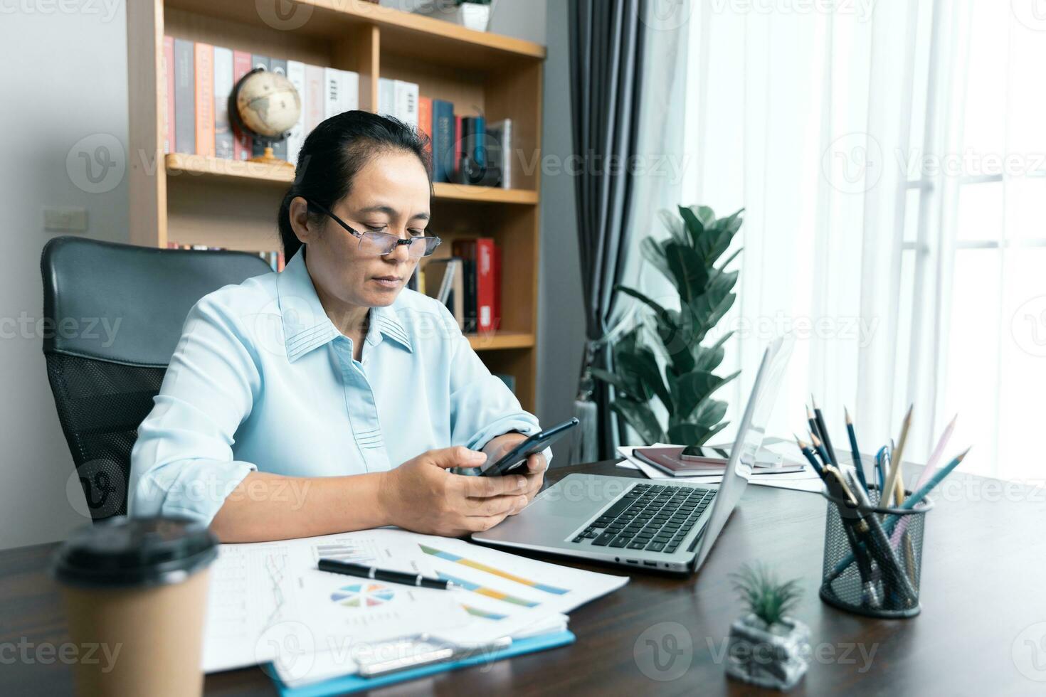 Businesswomen working to analyze, work together to discuss company financial statistics, brainstorm ideas, and graph documents on the table. photo