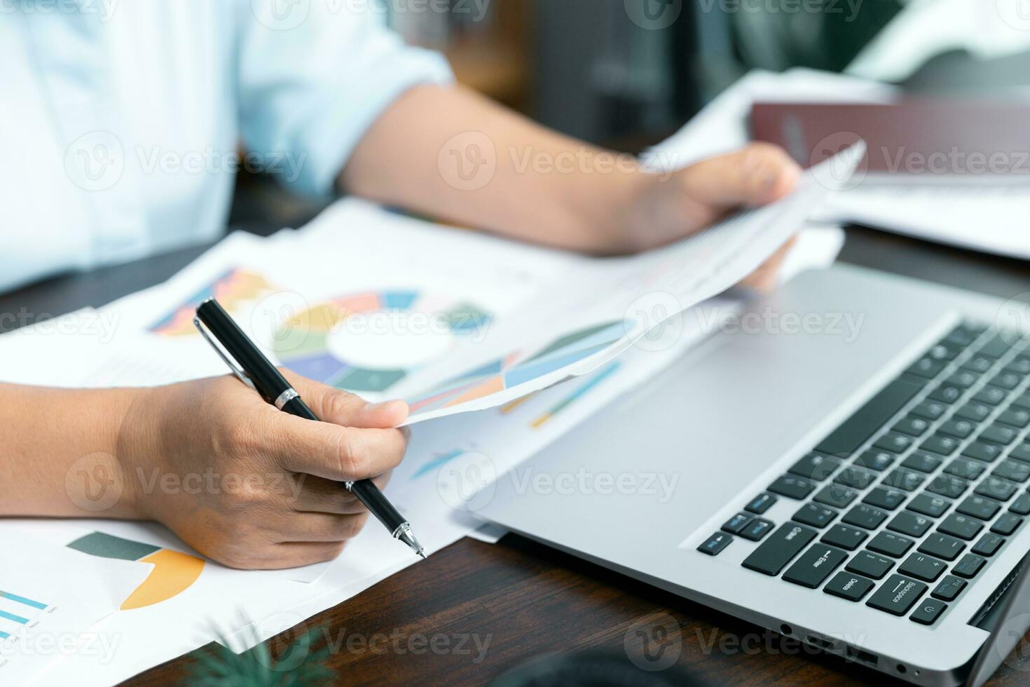 Businesswomen working to analyze, work together to discuss company financial statistics, brainstorm ideas, and graph documents on the table. photo