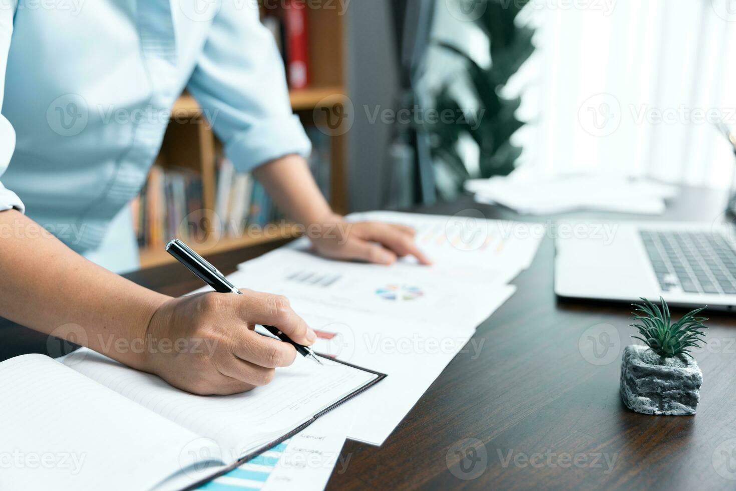 Businesswomen working to analyze, work together to discuss company financial statistics, brainstorm ideas, and graph documents on the table. photo