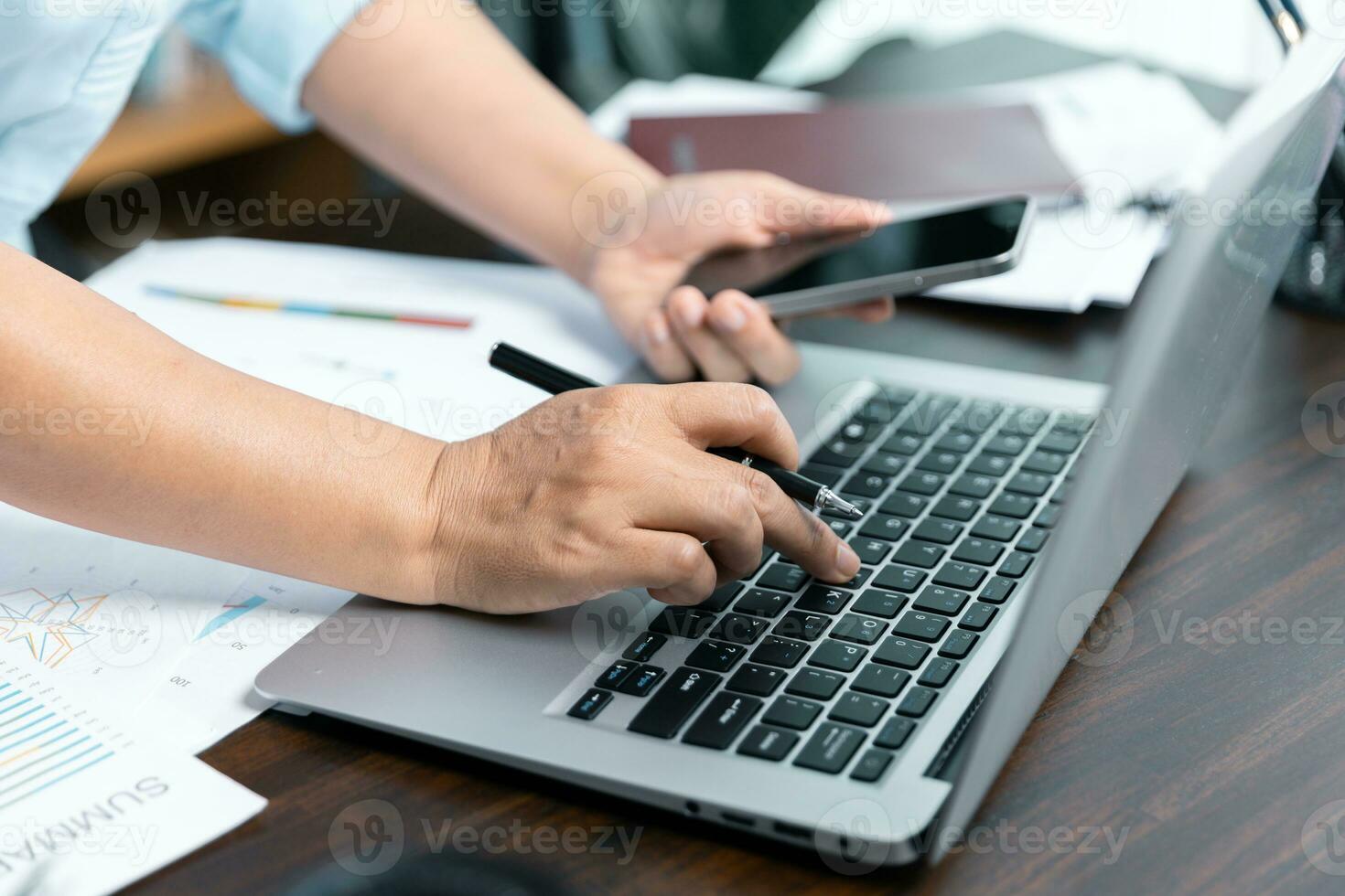 Businesswomen working to analyze, work together to discuss company financial statistics, brainstorm ideas, and graph documents on the table. photo