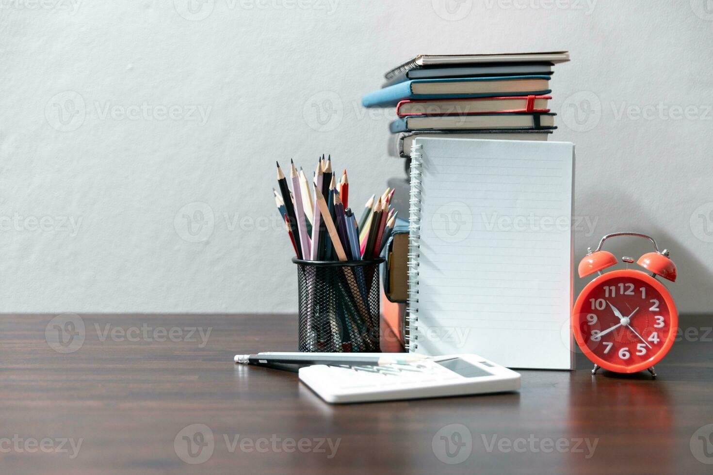 Back to school background with books on wooden table over chalkboard photo