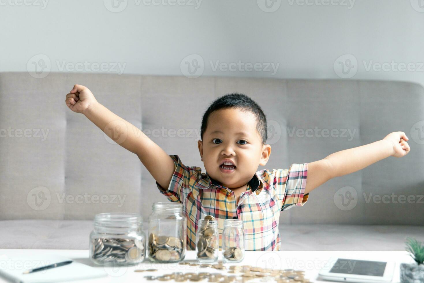 Preschooler child learning to calculate personal budget, manage finance, playing investment, accounting. Focused school kid saving money for purchase, putting cash in pink piggy bank at home. photo