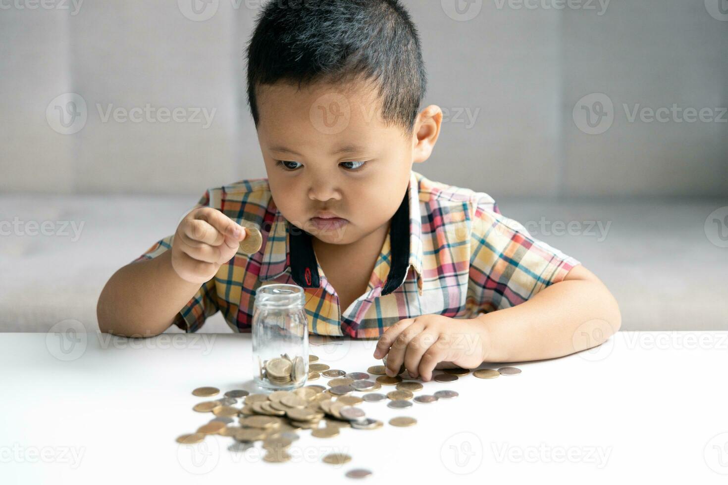 Preschooler child learning to calculate personal budget, manage finance, playing investment, accounting. Focused school kid saving money for purchase, putting cash in pink piggy bank at home. photo