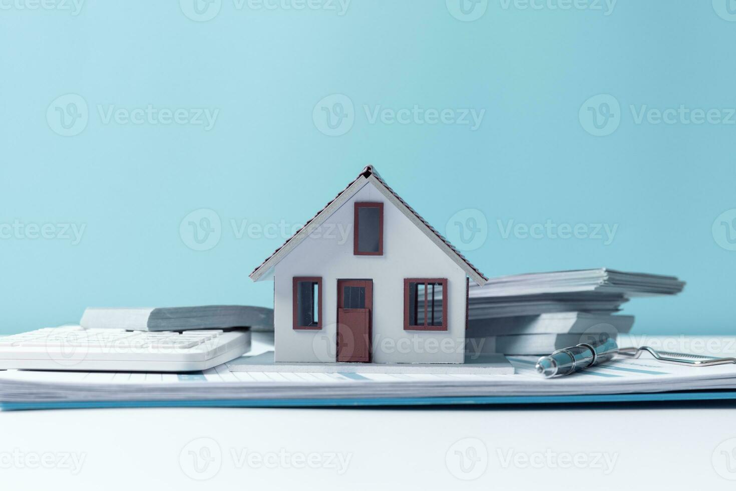 Property tax.investment planning.business real estate. View Of coin stack with house model, mortgage loading real estate property with loan money bank concept.Home sales and home insurance concept. photo