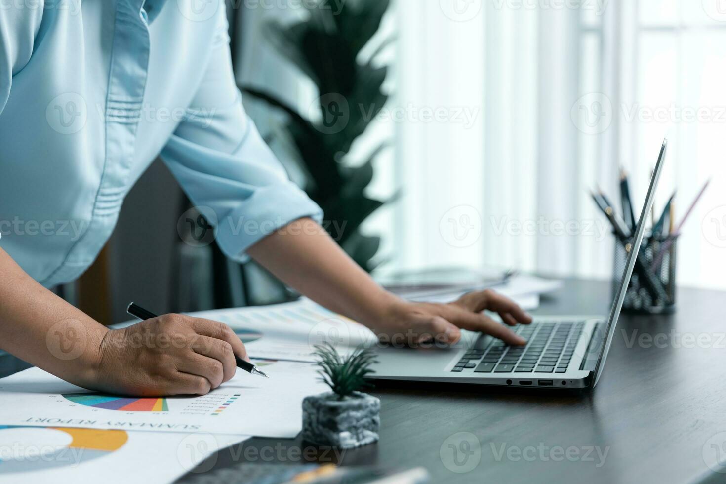 Businesswomen working to analyze, work together to discuss company financial statistics, brainstorm ideas, and graph documents on the table. photo