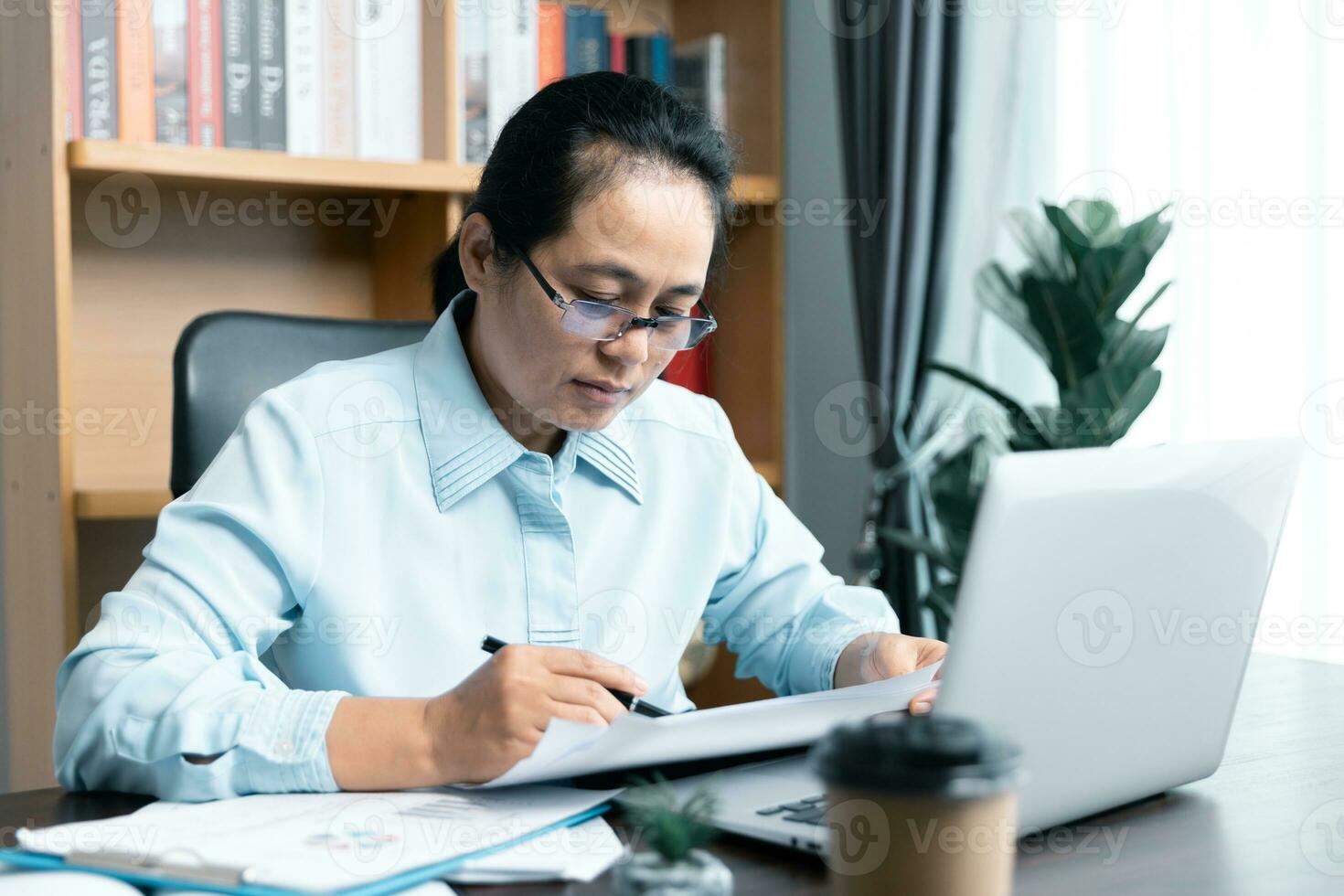 Businesswomen working to analyze, work together to discuss company financial statistics, brainstorm ideas, and graph documents on the table. photo