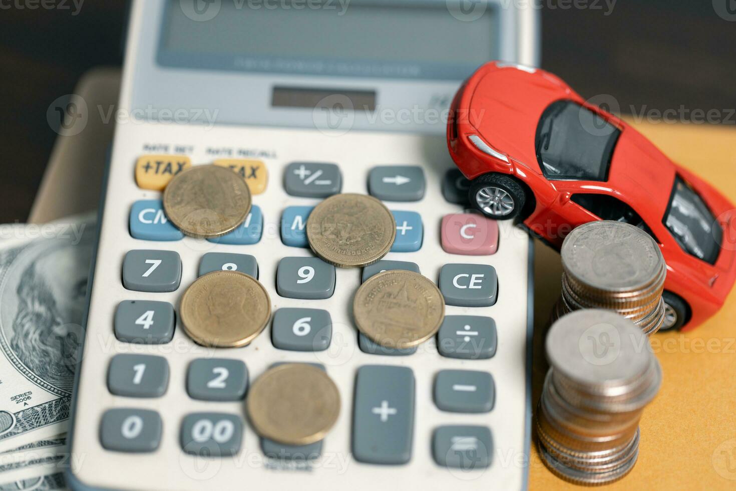 Miniature car model and Financial statement with coins. Finance and car loan, saving money for a car concepts. Car loan, money, banknote on agreement document or car insurance application form. photo