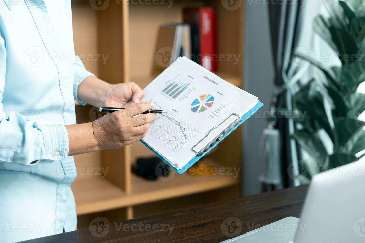Businesswomen working to analyze, work together to discuss company financial statistics, brainstorm ideas, and graph documents on the table. photo