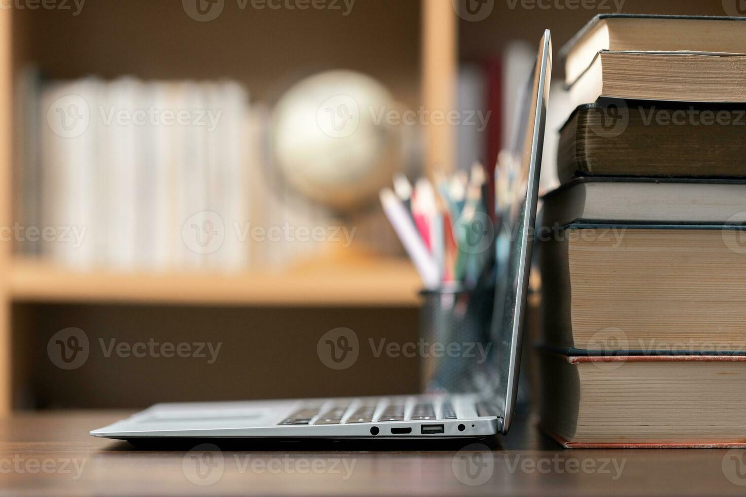 Education learning concept. Book in library with old open textbook, stack piles of literature text archive on reading desk, aisle of bookshelves in school study class room background for academic photo
