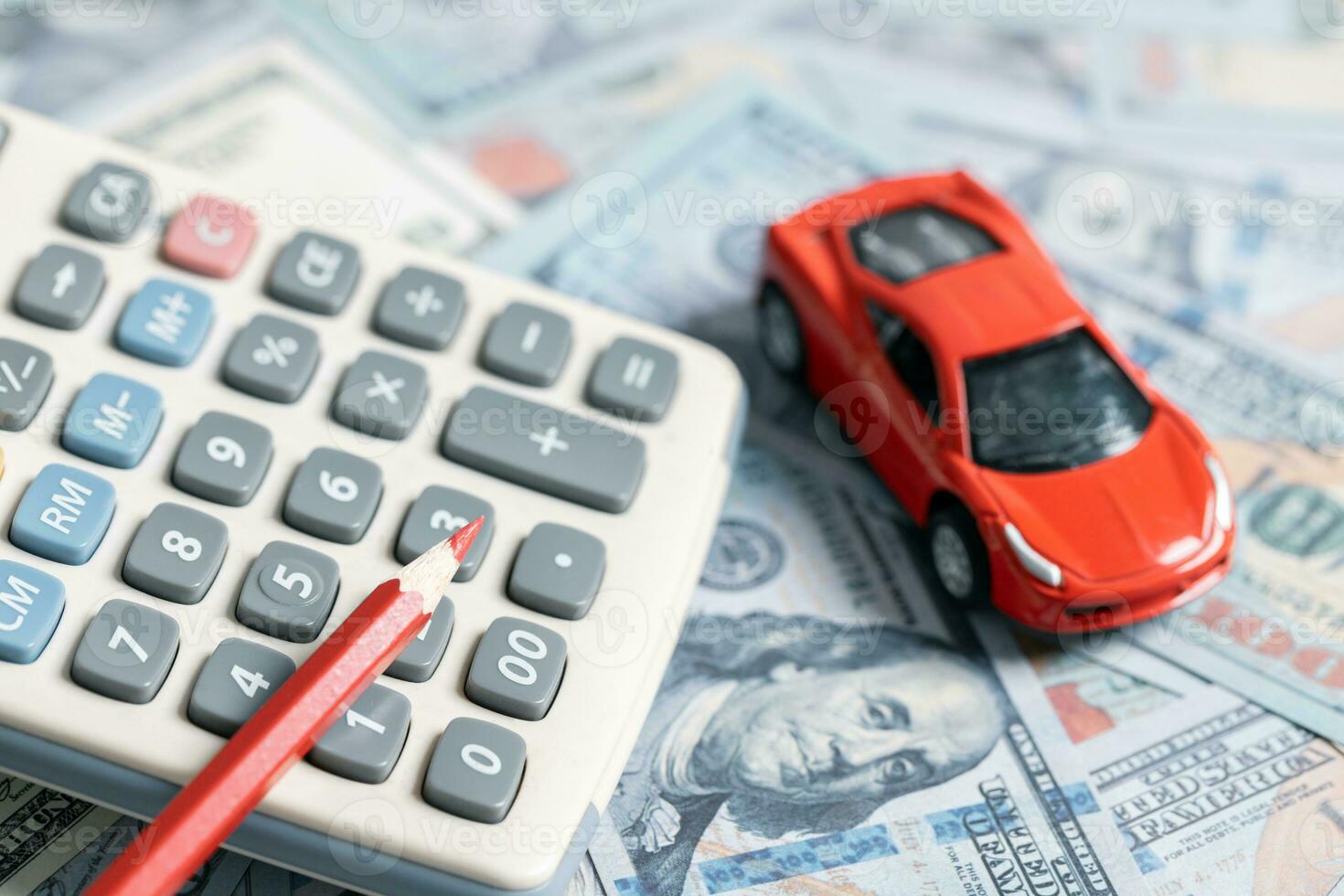 Top view of miniature car model, calculator and pen on office desk table. Business, finance, saving money, banking or car loan concept. Car, coins and calculator with copy space. photo
