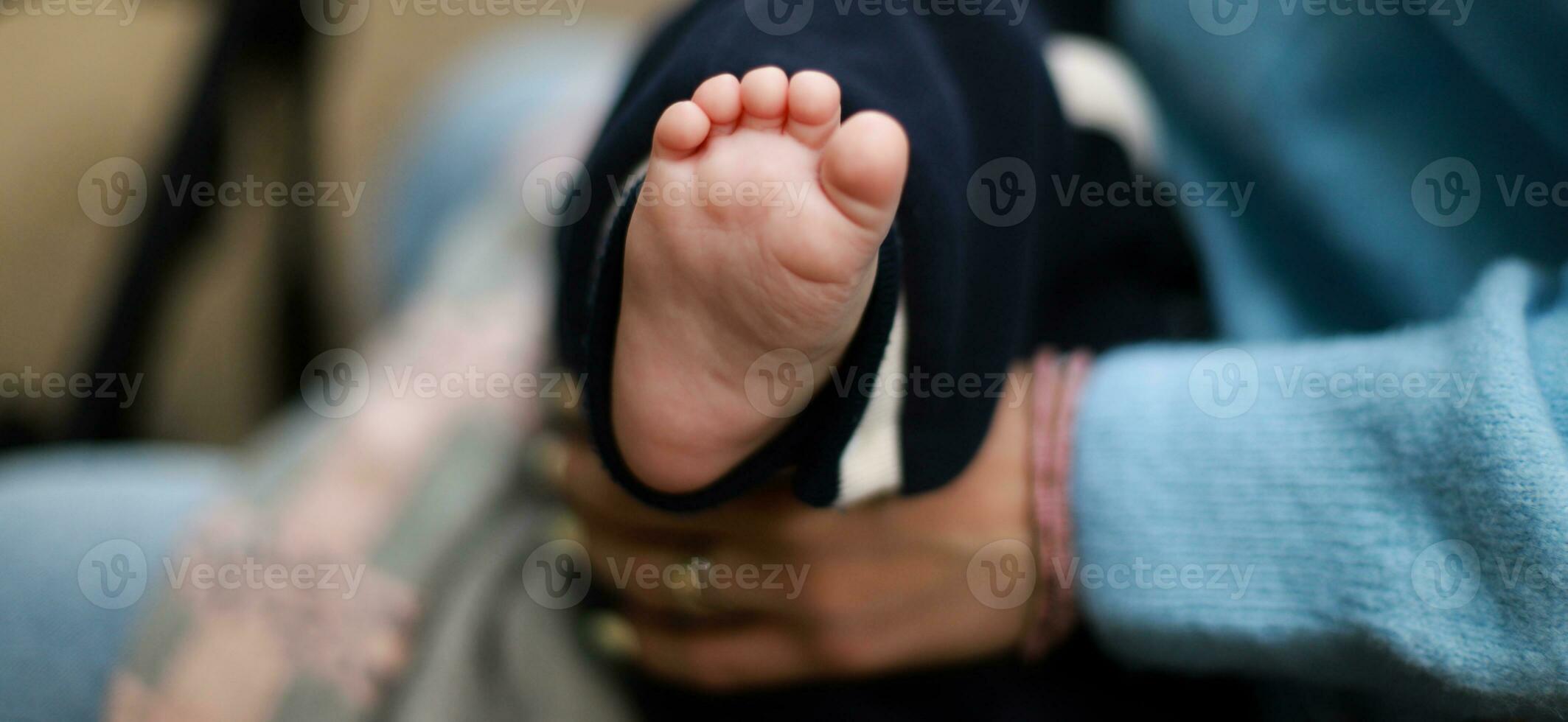 Banner The baby is in the arms of the mother. The newborn sleeps on the street. baby foot photo