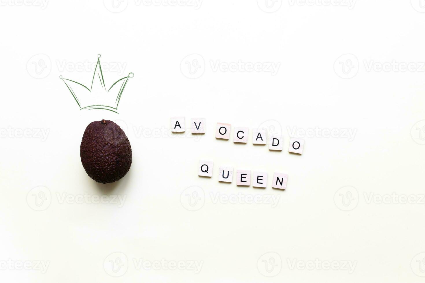 Avocado queen. A crown painted on a photo of an avocado. Flat lay lettering avocado queen